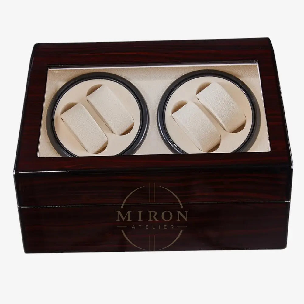 Wooden watch winder box with two compartments for watches inside.