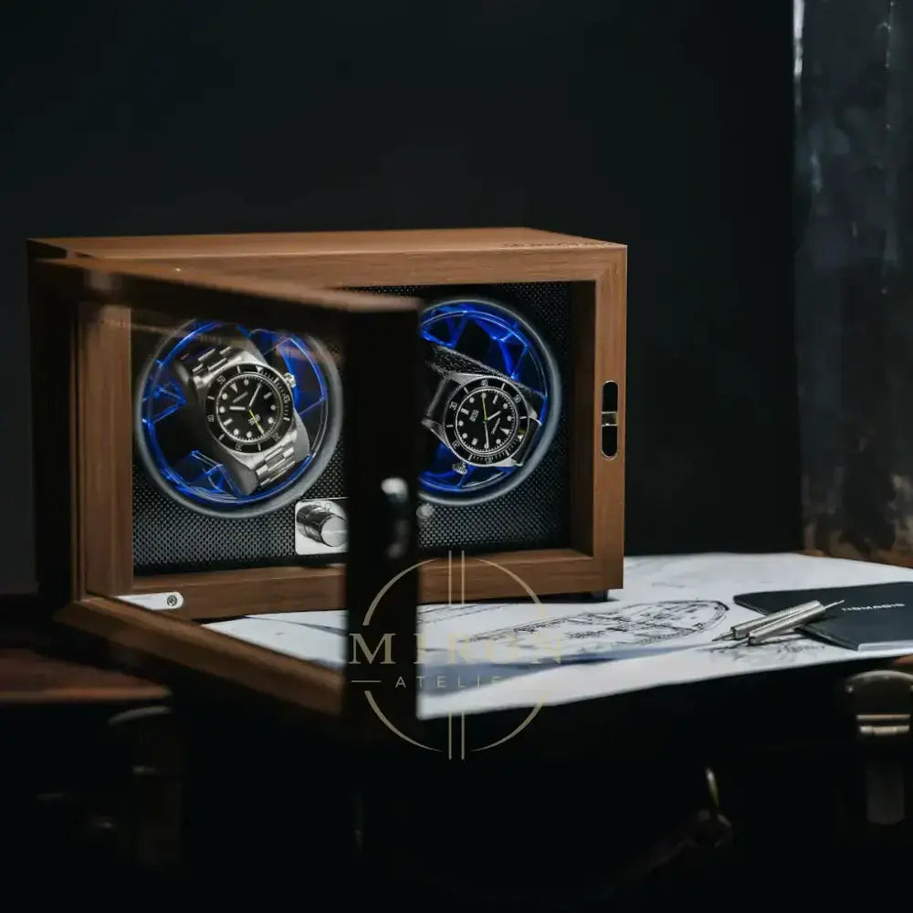 Wooden watch winder opened with two watches inside on a dark background