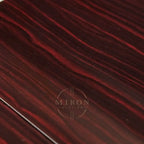 Close-up of a dark red and black ebony wooden surface