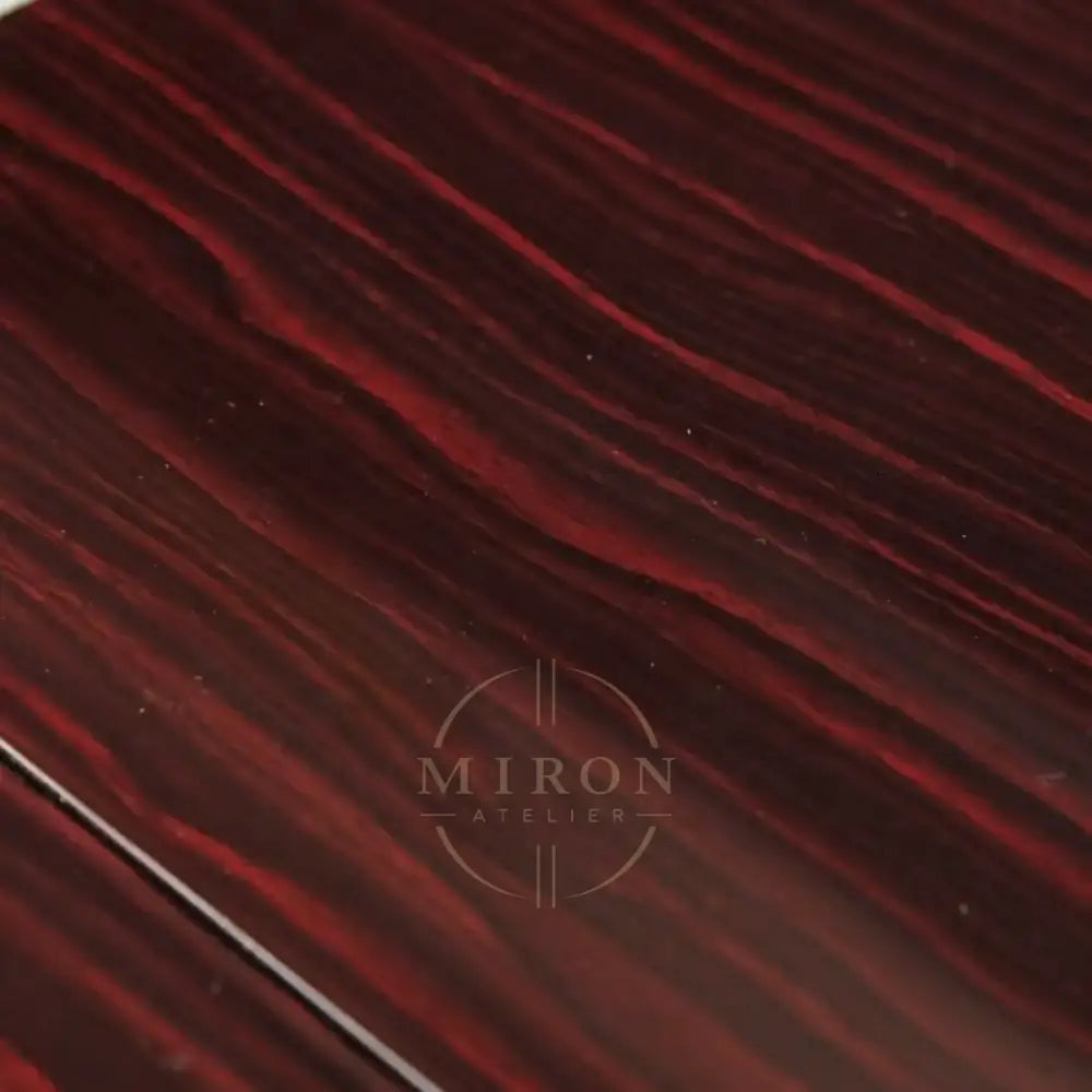Close-up of a dark red and black ebony wooden surface