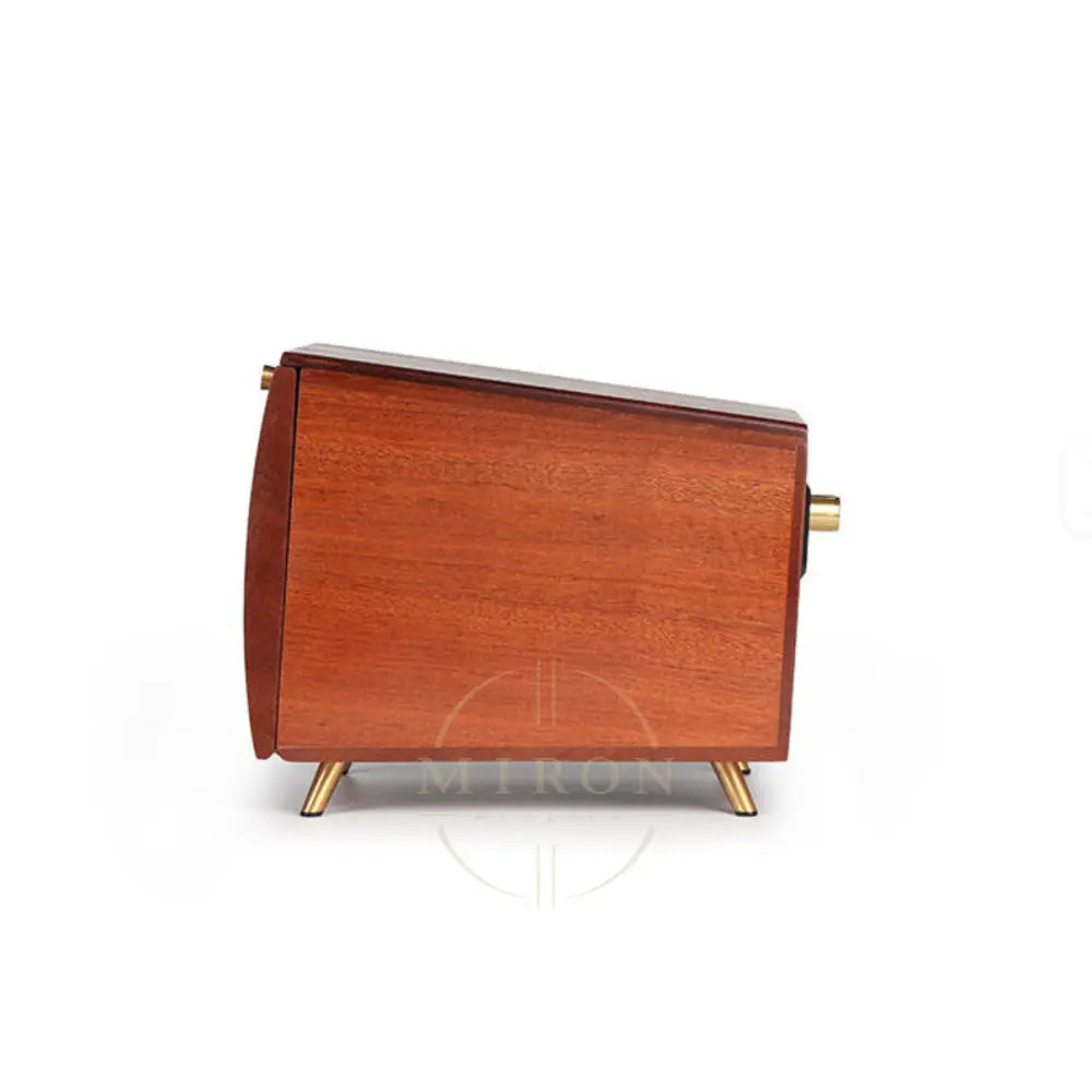 Wooden watch-box with gold accents on a white background