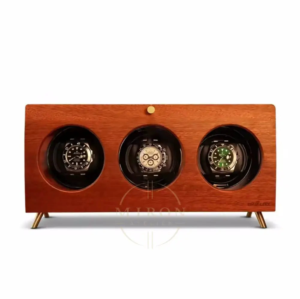 Wooden watch winder with three watches on a white background