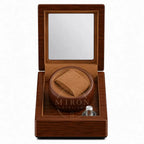 Wooden watch winder box with no watch inside on a white background