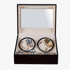 Open beige watch winder box with a lot of luxury watches inside on a white background