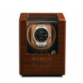Wooden watch winder with a Tissot watch inside on a white background